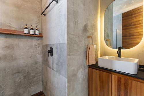 a bathroom with a sink and a mirror at Grand Loft with Rooftop Pool in the heart Cancun in Cancún