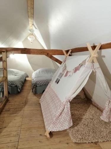 Cette chambre comprend 2 lits et un hamac. dans l'établissement Au petit bonheur à la campagne, à Lederzeele