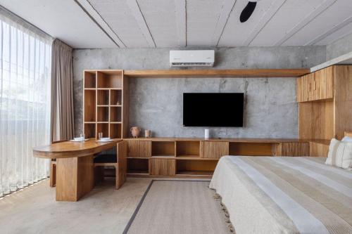 a bedroom with a desk and a tv on a wall at Grand Loft with Rooftop Pool in the heart Cancun in Cancún