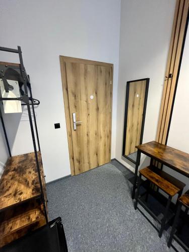 a room with a door and a table and a desk at Dream Aparts - Wschodnia 34 in Łódź