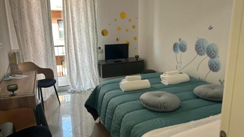 a bedroom with a green bed with pillows on it at Comfort Accommodation Room in Bergamo