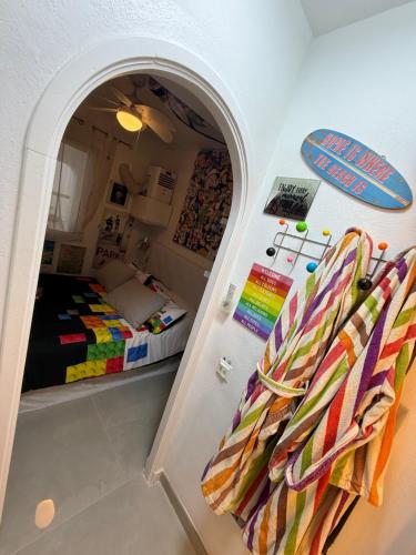 a bedroom with a bed and a surfboard on the wall at FLAT Surrounded by Nature WIFI & Pool & beach Nearby in Son Parc
