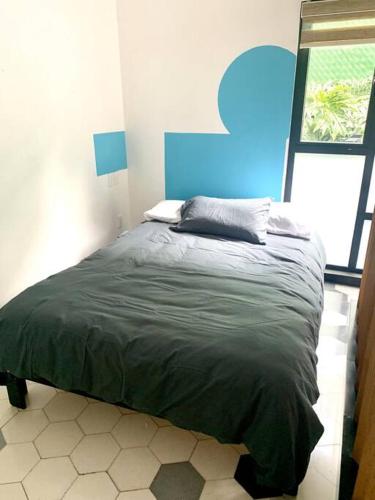 a bedroom with a bed in a room with a window at Nuevo Loft con Gym con Alberca y Terraza in Mexico City