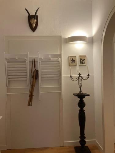 a room with white walls and a clock on the wall at Mosel - River - Quartier 31 in Lieser