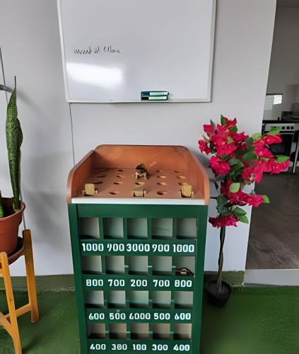a toy table with a shelf and a plant at Alojamiento San Francisco - Apartamentos y habitaciones in Lima