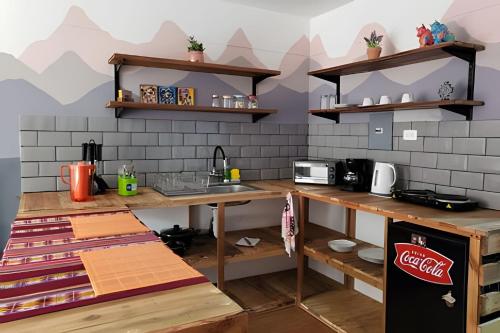 a kitchen with a counter and a sink in a room at Alojamiento San Francisco - Apartamentos y habitaciones in Lima