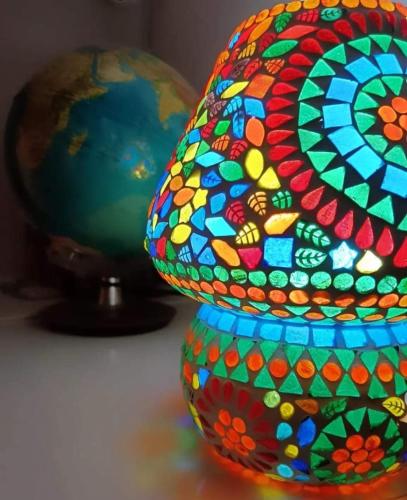 a colorful glass vase sitting next to a globe at Il Giramondo in Montelabbate