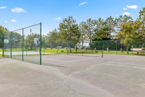 a tennis court with two tennis courts at Causeway On Gull Resort in Lake Shore