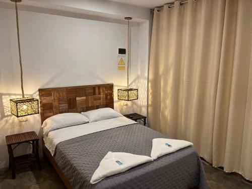 a bedroom with a bed with two towels on it at Hotel Chicama Home and lounge in Puerto Chicama