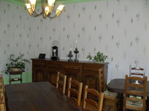a dining room with a wooden table and chairs and a dining room at Séjournez au cœur du pays de Jeanne d'Arc dans une maison avec 4 chambres uniques - FR-1-585-153 in Montigny-lès-Vaucouleurs