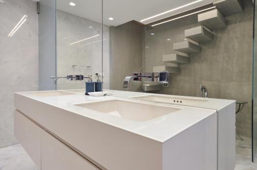 a bathroom with a white sink and a mirror at Soho Mews House in London