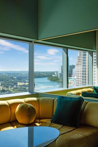 a couch in a room with large windows at W Austin in Austin