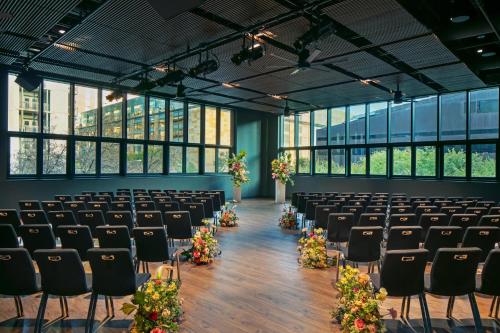 an empty room with rows of chairs and flowers at W Austin in Austin