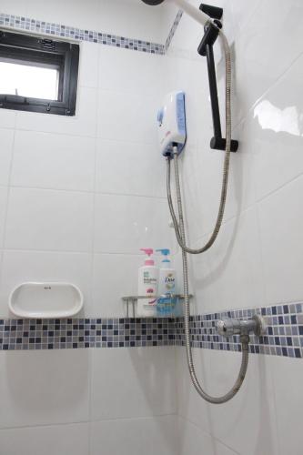 a shower in a bathroom with a shower head at Homeku Guesthouse Room 2 near airport at Latkrabang in Lat Krabang