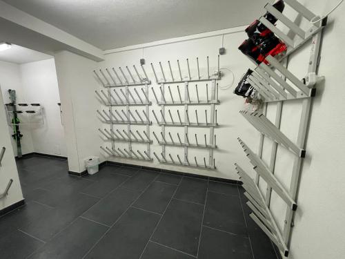 a room with a wall with a bunch of knives at Select Apartment Top 13by Alpina in Piesendorf