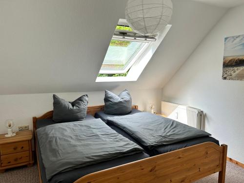 a bedroom with a bed with two pillows on it at Ferienwohnung Friesenstube in Zetel