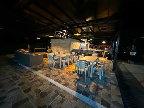 a patio with tables and chairs and a kitchen at Finca la Milagrosa in Popayan