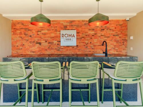 a group of chairs sitting in front of a bar at Roma 1888 in Guadalajara