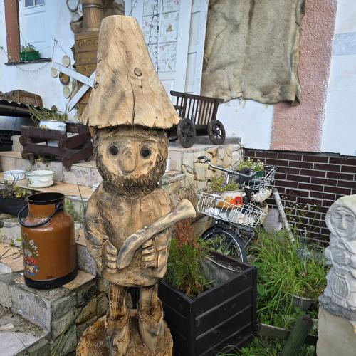 a statue of a bear with a hat on its head at Hostel Apollo in Ząbkowice Śląskie