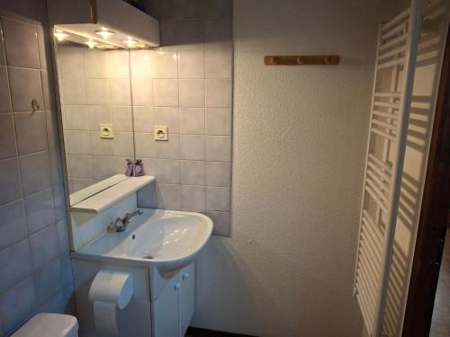 une salle de bain blanche avec un lavabo et des toilettes dans l'établissement Studio rénové 27m² avec balcon, wifi et parking - 4 pers., animaux admis - FR-1-512-283, à Brides-les-Bains