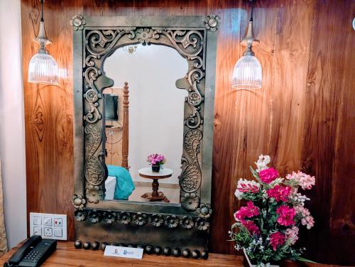 an ornate mirror on a wall in a room at Dip Holidays in Shānti Niketan