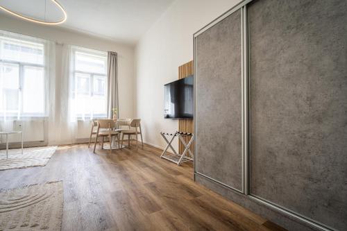 a living room with a large sliding glass door at Apartmánový Dům Centrum in Brno