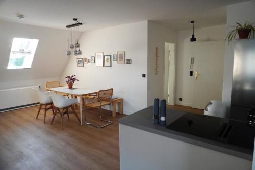a kitchen and dining room with a table and chairs at Wohnen im alten Standesamt No 6 in Pasewalk