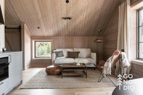 a living room with a couch and a table at The Reindeer Lodge including guesthouse in Tällberg