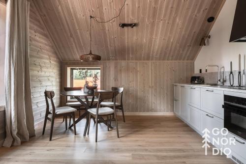 a kitchen with a dining room table and chairs at The Reindeer Lodge including guesthouse in Tällberg
