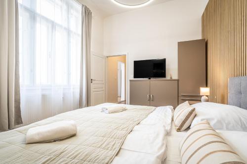 a bedroom with a large bed with two pillows on it at Apartmánový Dům Centrum in Brno
