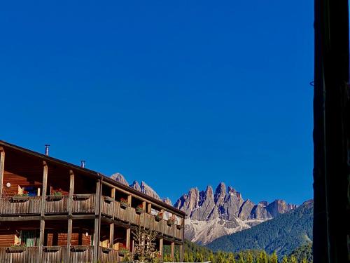 a building with a view of mountains in the background at Oberprantschöllhof - Horse Mountain Stable in Bressanone