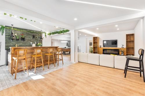 a kitchen and living room with a table and chairs at Casa Chameleon in Almancil