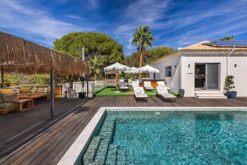 a villa with a swimming pool and a deck at Casa Chameleon in Almancil
