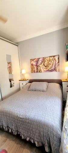 a bedroom with a bed and a painting on the wall at Beach apartment Suzy&Demi in Split
