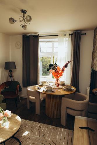 a living room with a table and a window at Bromley Stylish Modern Escape 2 Bed Apartment in Bickley