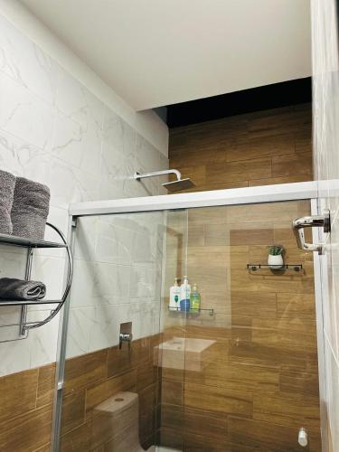 a shower with a glass door in a bathroom at Casa Don José TULIPANES Suite in Oaxaca City