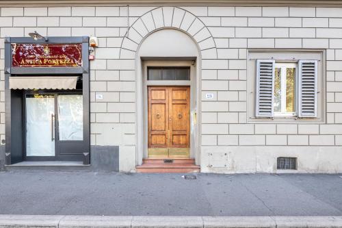 a building with a wooden door and a window at La Fortezza in Florence