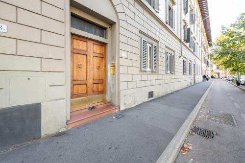 a building with a wooden door on the side of a street at La Fortezza in Florence