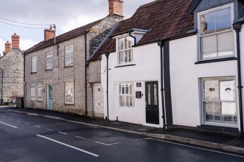 a row of white buildings on a street at Tiny House, Stunning 1 Bed, Super King, Freestanding Bath, Parking in Somerton