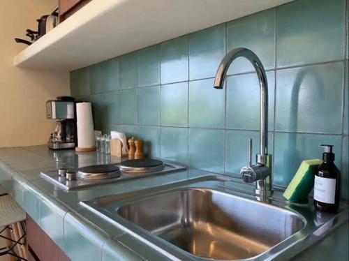 a kitchen with a sink and a counter top at Chic Loft Steps from the Beach in Holbox Island