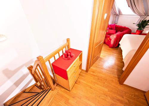a room with a staircase with a couch and a table at Heart Bled in Bled