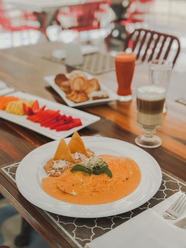 a table with a plate of food on a table at Hotel Catedral La Paz in La Paz