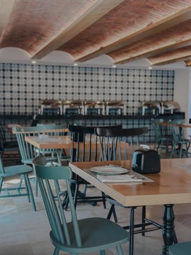 a dining room with wooden tables and chairs at Hotel Catedral La Paz in La Paz