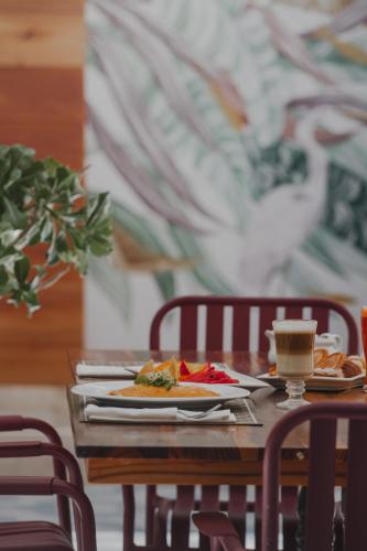 a table with a plate of food and a cup of coffee at Hotel Catedral La Paz in La Paz