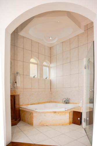 a bathroom with a bath tub in a room at Casa Conde Hotel & Apartamentos in San José