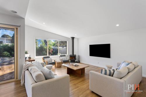 a living room with two couches and a flat screen tv at Renovated Lux Property in Quiet Estate in Cowes