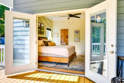 a bedroom with a bed and a sliding glass door at Waterfront Lake Hickory Retreat with Private Dock! in Hickory