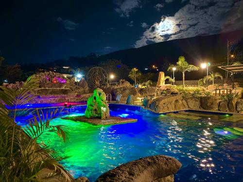a pool at night with a water park at Hotel Casa Cantabria Campestre in Villa de Leyva