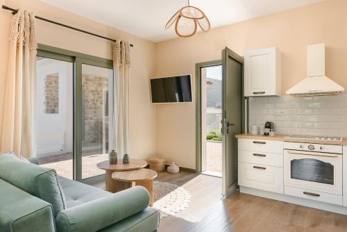 a living room with a couch and a kitchen at aZOLAki Suites in Zóla