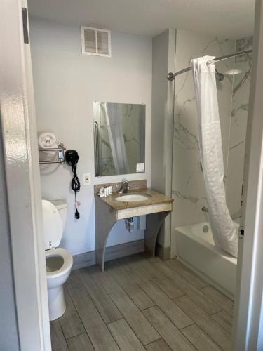 a bathroom with a sink and a toilet and a shower at Baymont by Wyndham Rock Hill in Rock Hill